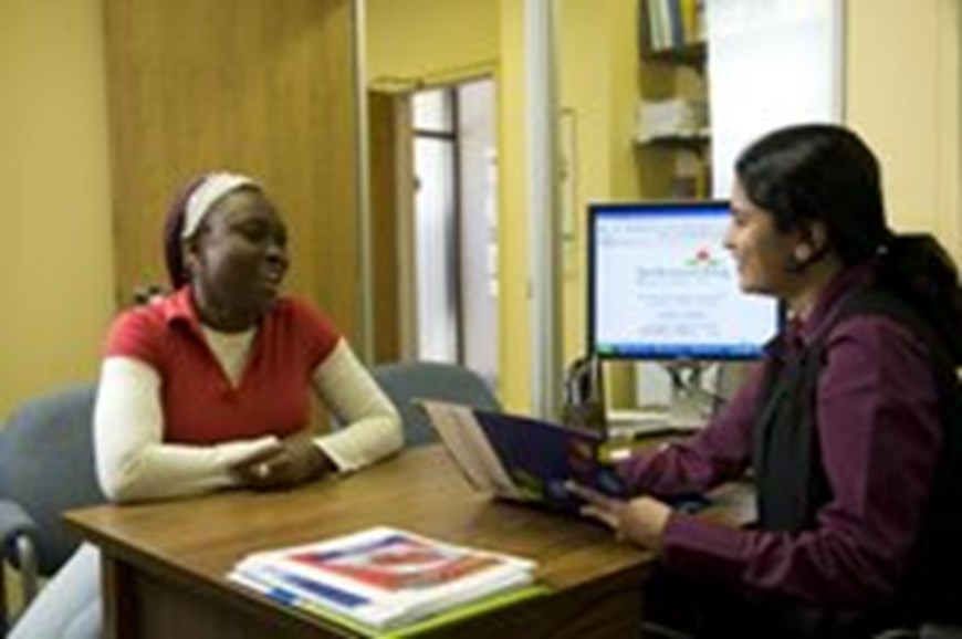 A client and worker in an office at the Multicultural Centre