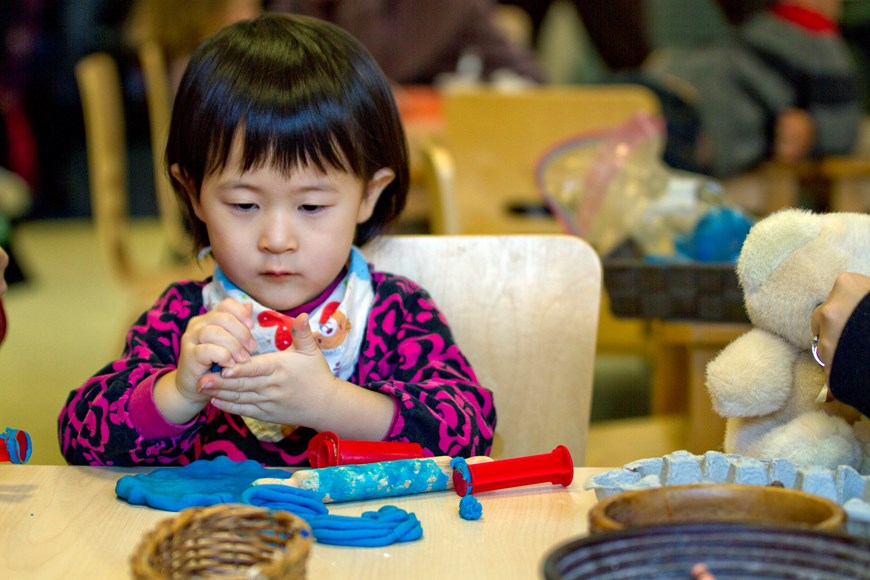 Child doing a craft in a classroom