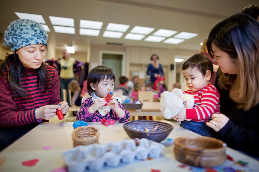 Two mothers play with their children at the Early Years Centre