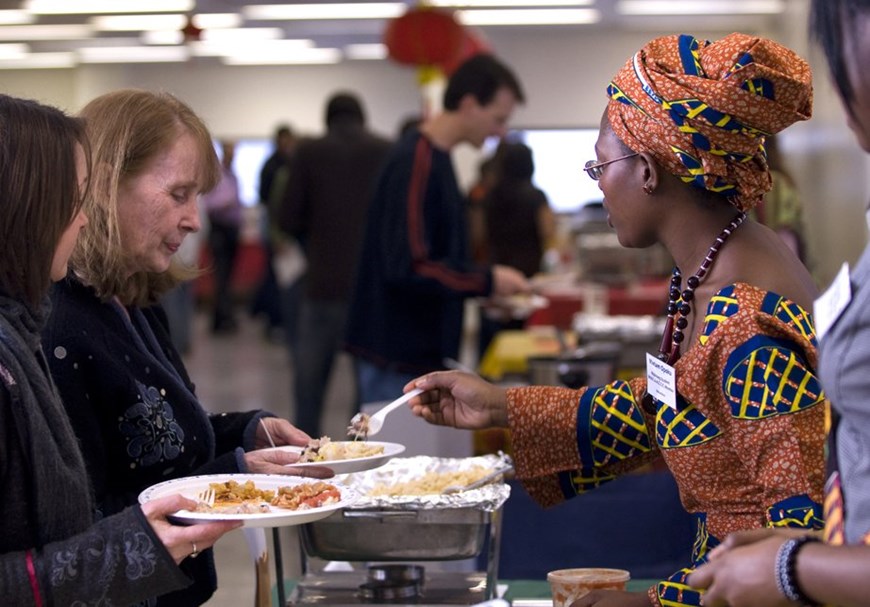 People being served food at the International Food Fest