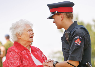 North Bay Police officer assisting a senior woman.